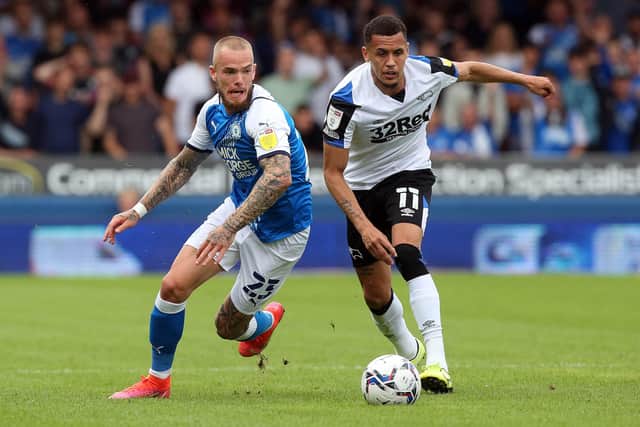 Joe Ward of Peterborough United in action with Ravel Morrison of Derby County. Photo: Joe Dent/theposh.com.