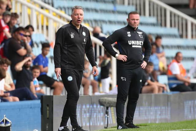 Posh manager Darren Ferguson with Derby boss Wayne Rooney at the Weston Homes Stadium. Photo: Joe Dent/theposh.com.