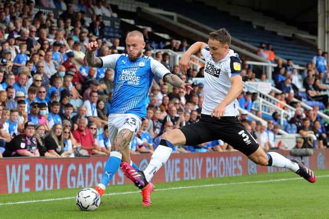 Joe Ward of Peterborough United in action with Craig Forsyth of Derby County. Photo: Joe Dent/theposh.com.