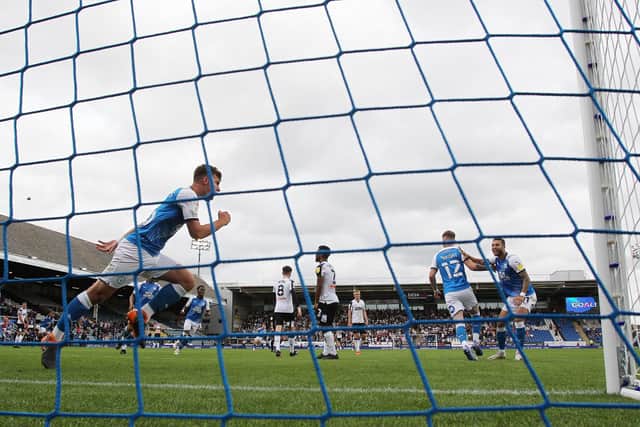 Harrison Burrows of Peterborough United wheels away to celebrate scoring the equalising goal against Derby County. Photo: Joe Dent/theposh.com.
