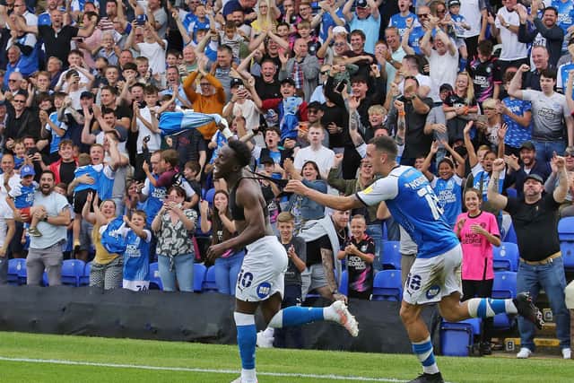 Siriki Dembele of Peterborough United celebrates the winning goal against Derby with team-mate Oliver Norburn. Photo: Joe Dent/theposh.com.