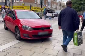 A red Volkswagan parked illegally on Long Causeway. Photo: Cllr Wayne Fitzgerald.