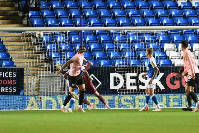 Aden Flint powers home the first Cardiff goal against Posh. Photo: David Lowndes.