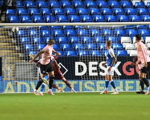 Aden Flint powers home the first Cardiff goal against Posh. Photo: David Lowndes.