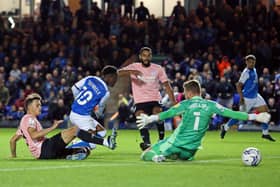 Siriki Dembele of Peterborough United gets the better of Perry Ng of Cardiff City to score the second goal of the game. Photo: Joe Dent/theposh.com.