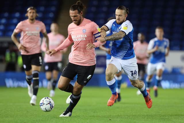 Jack Marriott of Peterborough United puts pressure on Sean Morrison of Cardiff City. Photo: Joe Dent/theposh.com.