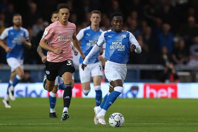 Siriki Dembele of Peterborough United gets away from Perry Ng of Cardiff City. Photo: Joe Dent/theposh.com.