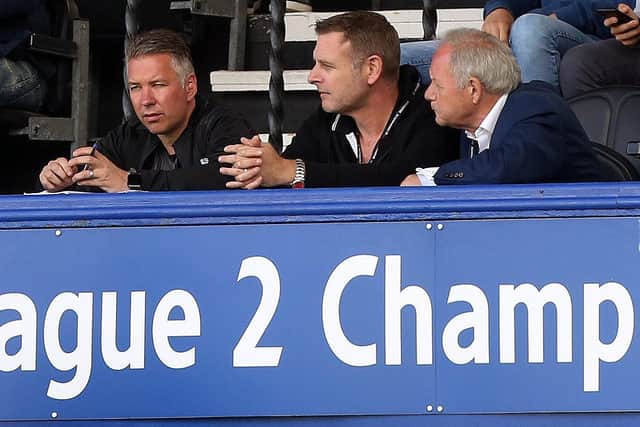 Darragh MacAnthony (centre) flanked by Posh manager Darren Ferguson (left) and director of football Barry Fry (right).