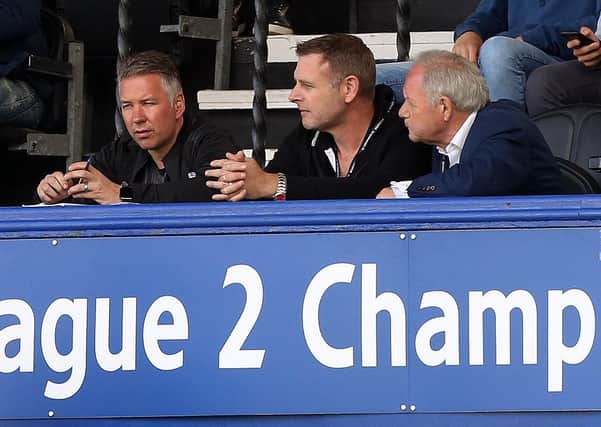 Darragh MacAnthony (centre) flanked by Posh manager Darren Ferguson (left) and director of football Barry Fry (right).