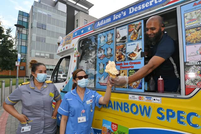 Wajid Hussain hands out free ice cream to workers at Peterborough City Hospital.