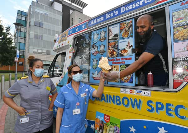 Wajid Hussain hands out free ice cream to workers at Peterborough City Hospital.