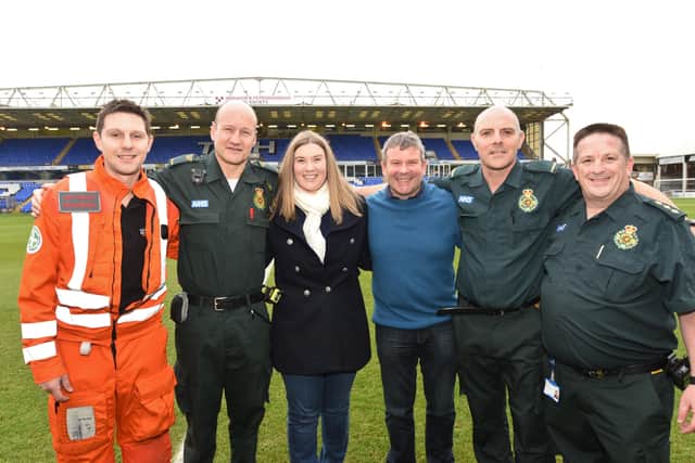 MAGPAS paramedic Dan Phillips with East Anglian Ambulance Service paramedics Del Ferguson , Mark Chapman and ambulance manager Mark Parnell with Emily and Paul Starr (who has cardiac arrest at Posh match) EMN-161112-184958009