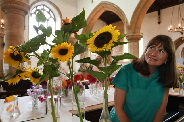 Castor Village Show at St Kyneburgha Church, Castor. Sue Edwards with sunflowers EMN-210821-194615009