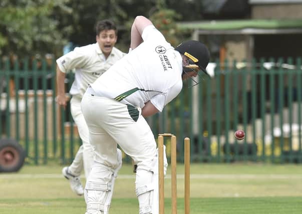 Newborough batsman Greg Rowland is bowled by Aaron Magee of Whittlesey. Photo: David Lowndes.