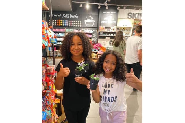 Shoppers at LUSH enjoy their free plants.