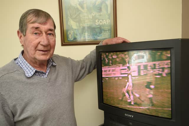 Peter McNamee watching a video of Posh beating Arsenal in an FA Cup tie in 1965.