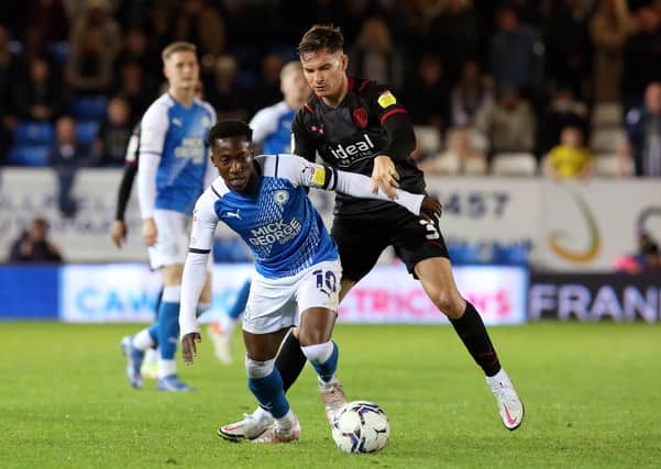 Siriki Dembele of Peterborough United in action with Conor Townsend of West Bromwich Albion. Photo: Joe Dent/theposh.com.