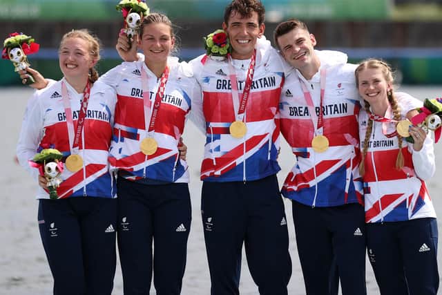 (From left) Ellen Buttrick, Giedre Rakauskaite, James Fox, Oliver Stanhope and Coxswain Erin Kennedy of Team Great Britain PR3 Mixed Coxed Four celebrates during the victory ceremony after winning the Gold medal on day 5 of the Tokyo 2020 Paralympic Games at Sea Forest Waterway. Photo: Naomi Baker/Getty Images.