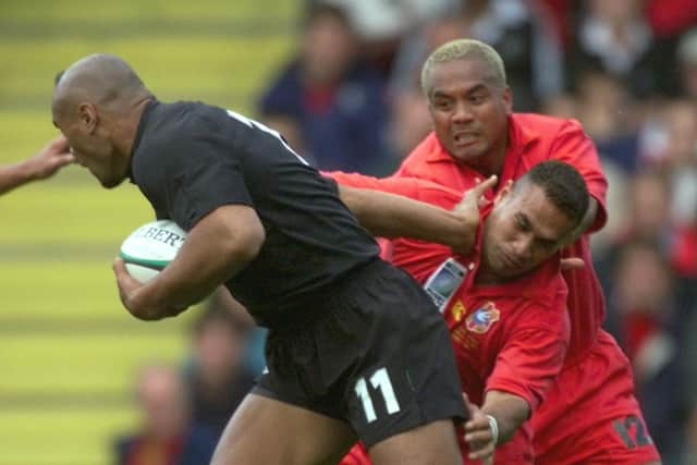 New Peterborough Lions coach Tevita Tiueti is brushed aside by All Black great Jonah Lomu in the 1999 World Cup. Photo: Olivier Moring /AFP via Getty Images).