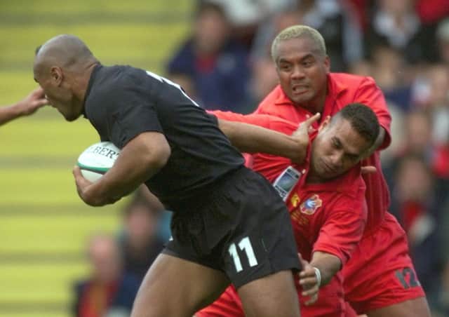 New Peterborough Lions coach Tevita Tiueti is brushed aside by All Black great Jonah Lomu in the 1999 World Cup. Photo: Olivier Moring /AFP via Getty Images).