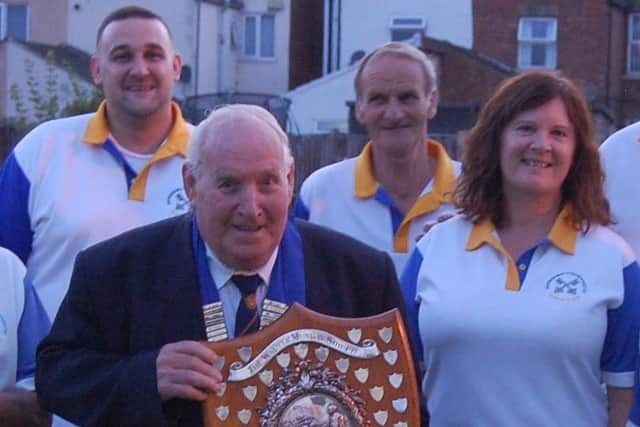 Conservative receive the Munday Shield from Peterborough League president Adrian Owen.