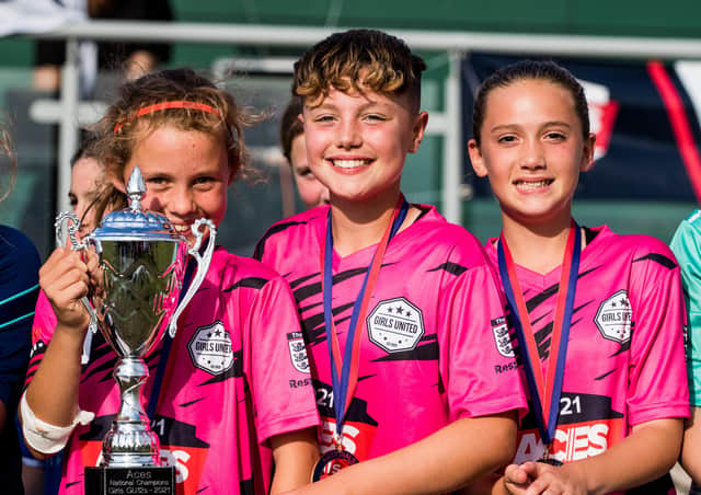 Girls United players, from left, Harper Graham, Isla Wales and Bonnie Blake celebrate their National success in Nottingham.
