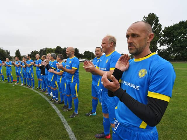 Players take part in a minute's applause before the Ian Fovargue memorial match at Nene Valley Community Centre. Pictures: David Lowndes
