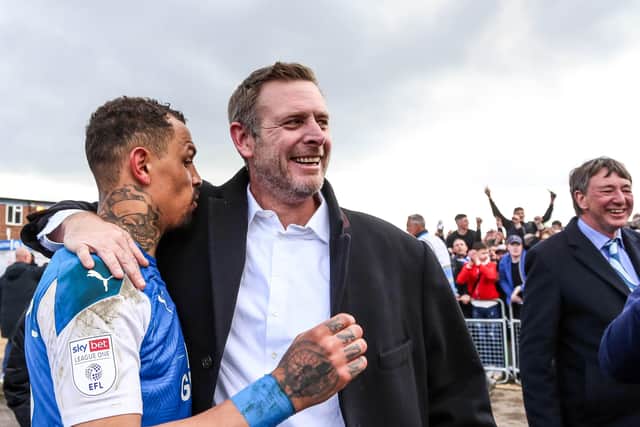 Darragh MacAnthony with current Posh striker Jonson Clarke-Harris.