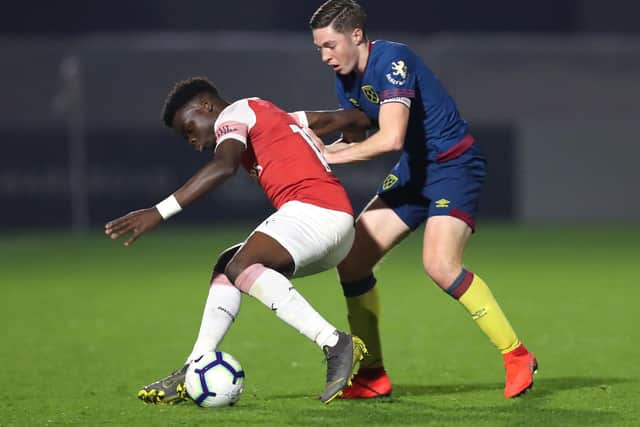Bukayo Saka of Arsenal is challenged by Conor Coventry of West Ham United during the Premier League 2 match between Arsenal and West Ham United at Meadow Park on March 29, 2019. Photo: Getty Images.