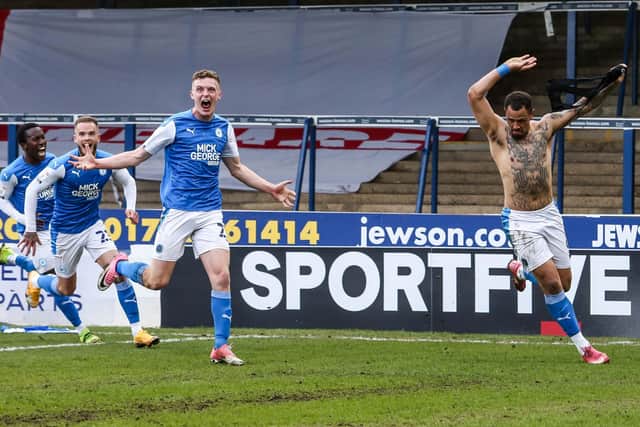 Jonson Clarke-Harris (minus shirt) celebrates his promotion-winning goal against Lincoln.