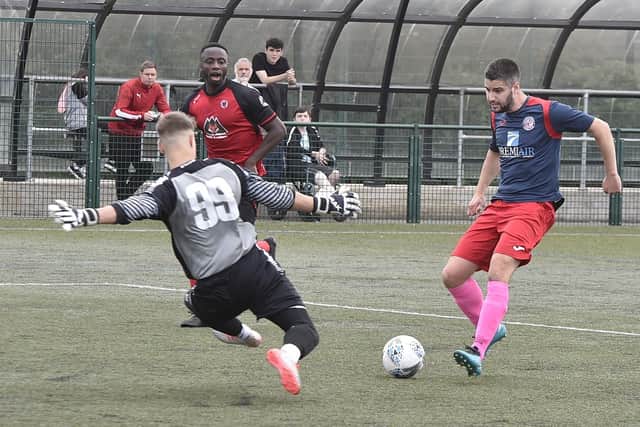 Netherton goalkeeper Bartosz Berezowski thwarts Wittering Premiair striker Andrew Moss in Saturday’s Peterborough Premier Division game at the Grange. Photo: David Lowndes.