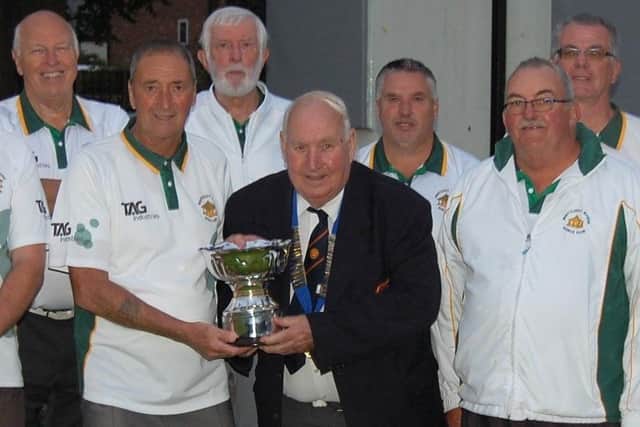 Whittlesey Manor receive the Albert Rowlett Cup from Peterborough League president Adrian Owen.