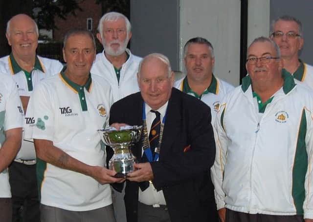 Whittlesey Manor receive the Albert Rowlett Cup from Peterborough League president Adrian Owen.