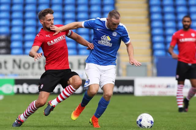 Conor Hourihane (left) in action for Barnsley against Posh.