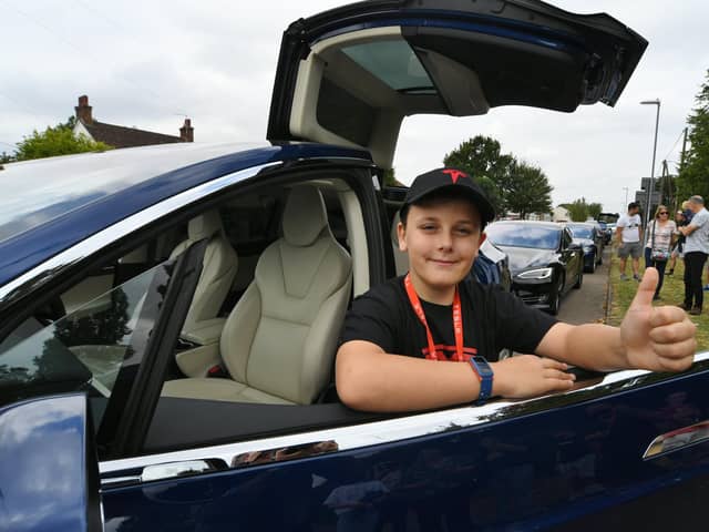 Harvey Ahern-Sutliff whose 10th birthday treat was seeing a convoy of Tesla cars at Stilton EMN-210409-201553009