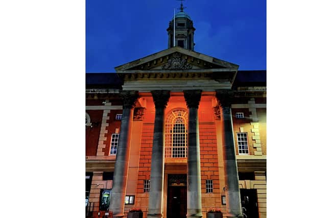 The town hall was bathed in orange light