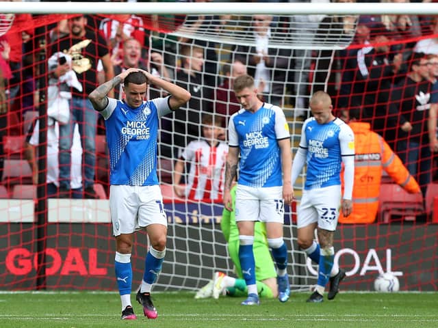 Oliver Norburn (left) of Peterborough United and team-mates cut dejected figures as after Sheffield United score. Photo: Joe Dent/theposh.com.