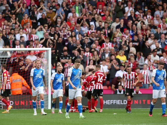 Peterborough United players cut dejected figures after Sheffield United score. Photo: Joe Dent/theposh.com.