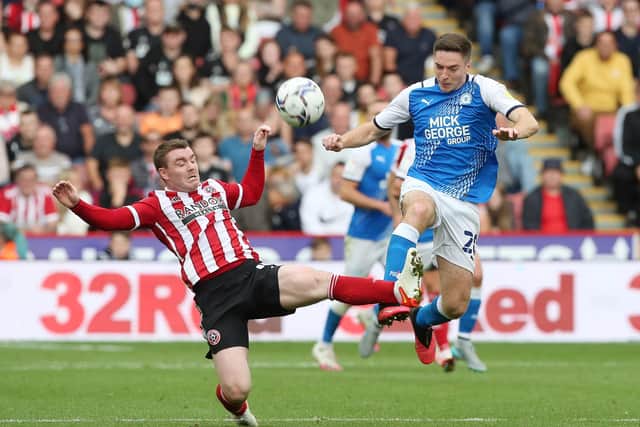 Debutant Conor Coventry of Peterborough United in action with John Fleck of Sheffield United. Photo: Joe Dent/theposh.com.