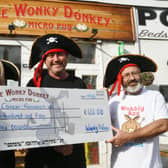 Andy and Dave Williams  from the Wonky Donkey at Fletton High Street presenting a cheque to Gaynor Jackson of Cancer Research UK EMN-210918-172308009