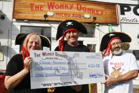 Andy and Dave Williams  from the Wonky Donkey at Fletton High Street presenting a cheque to Gaynor Jackson of Cancer Research UK EMN-210918-172308009