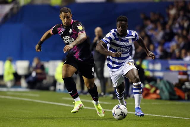 Jonson Clarke-Harris of Peterborough United in action with Andy Yiadom of Reading. Photo: Joe Dent/theposh.com.