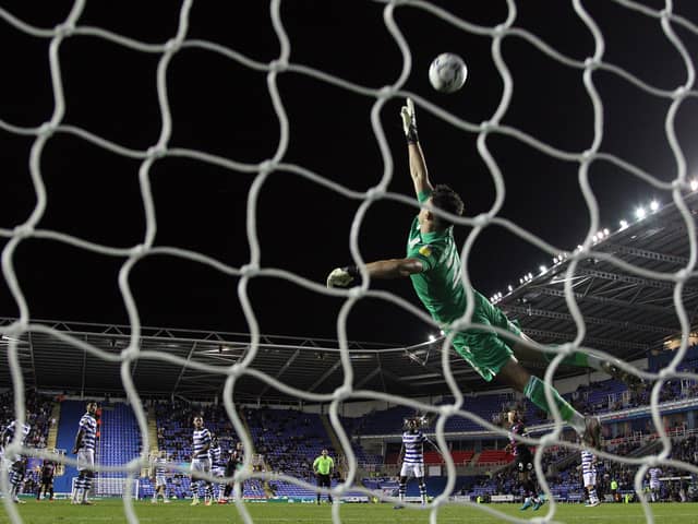 Luke Southwood of Reading makes a diving save to deny a shot from Oliver Norburn of Peterborough United - Mandatory by-line: Joe Dent/JMP - 14/09/2021 - FOOTBALL - Select Car Leasing Stadium - Reading, England - Reading v Peterborough United - Sky Bet Championship