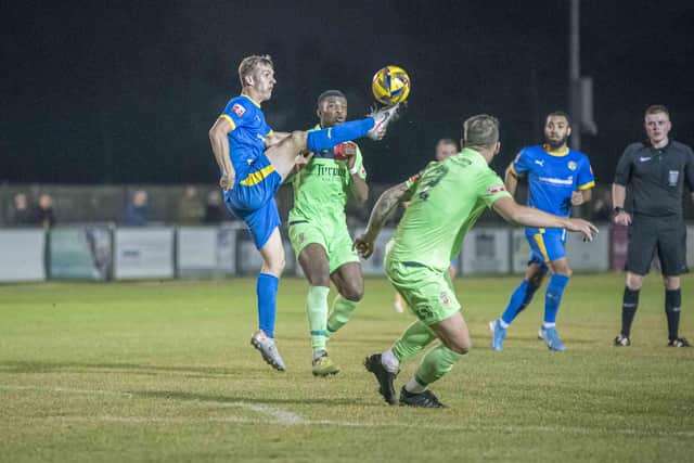 Dan Jarvis of Peterborough Sports (blue) in action against Tamworth. Photo: James Richardson.
