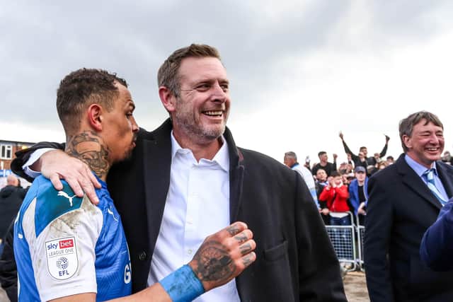 Posh chairman Darragh MacAnthony with Jonson Clarke-Harris.