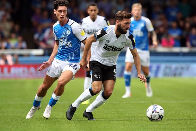 Joel Randall (blue) in action for Posh against Derby last month. Photo: Joe Dent/theposh.com.
