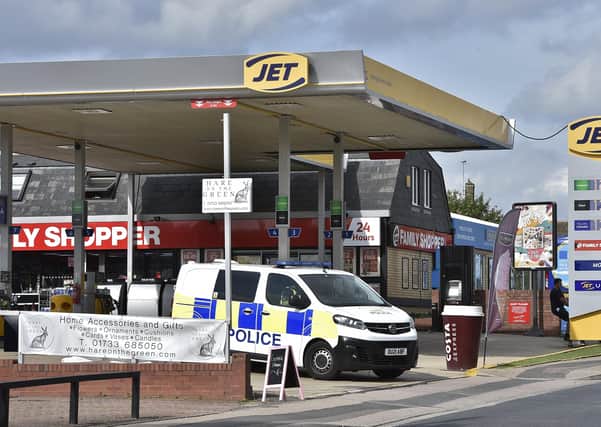 Police tape off the JET petrol station in Werrington.
