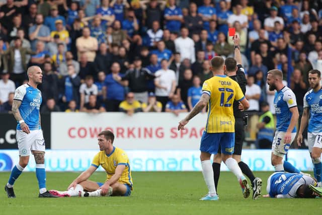 Gary Gardner of Birmingham City (seated) is shown a straight red card for a foul on Nathan Thompson by referee Jarred Gillett. Photo: Joe Dent/theposh.com.