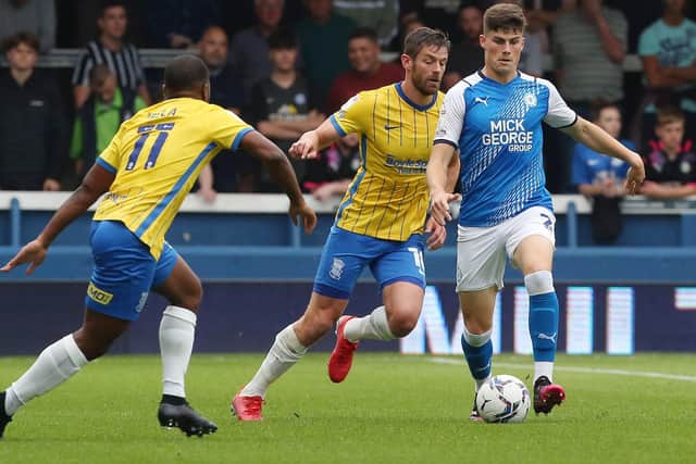 Ronnie Edwards of Peterborough United gets away from Lukas Jutkiewicz of Birmingham City. Photo: Joe Dent/theposh.com.