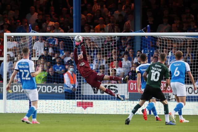 David Cornell makes a diving save against Plymouth Argyle - Photo: Joe Dent/JMP.